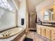 Bathroom featuring a large window above the soaking tub, shower, and vanity at 18963 E Long Ave, Centennial, CO 80016