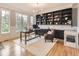 Spacious home office featuring custom built-ins, hardwood floors, and plenty of natural light from large windows at 18963 E Long Ave, Centennial, CO 80016