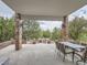 Covered patio with dining table, chairs and outdoor fireplace provides a relaxing entertainment space at 18963 E Long Ave, Centennial, CO 80016