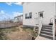 Grass backyard with steps leading to a patio at 4715 Crestone Peak St, Brighton, CO 80601