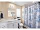 Bathroom with white vanity and blue shower curtain at 4715 Crestone Peak St, Brighton, CO 80601