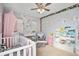 Bedroom with crib, changing table, and bookcase at 4715 Crestone Peak St, Brighton, CO 80601