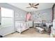 Bedroom with crib, changing table, and plenty of storage at 4715 Crestone Peak St, Brighton, CO 80601