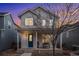 Two-story house with blue door and porch at 4715 Crestone Peak St, Brighton, CO 80601