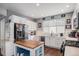 Modern kitchen with white cabinets, stainless steel appliances, and an island at 4715 Crestone Peak St, Brighton, CO 80601