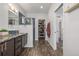 Bathroom with dual sinks, glass enclosed shower, and custom closet with organizers at 1754 W 66Th Ave, Denver, CO 80221