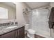 Modern bathroom featuring granite countertops, glass shower, and white subway tile at 1754 W 66Th Ave, Denver, CO 80221