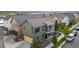 Aerial shot of home with two-car garage, green siding, balcony, and fenced patio, perfect for outdoor enjoyment at 1754 W 66Th Ave, Denver, CO 80221