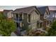 Charming exterior featuring a covered porch, a second-story balcony, green siding, and manicured landscaping at 1754 W 66Th Ave, Denver, CO 80221