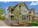 Two-story home with a covered balcony, charming yard, and stylish exterior siding at 1754 W 66Th Ave, Denver, CO 80221
