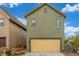 Green garage with bright yellow door at 1754 W 66Th Ave, Denver, CO 80221