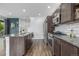 Modern kitchen featuring stainless steel appliances, granite countertops, and a view of the stairs at 1754 W 66Th Ave, Denver, CO 80221