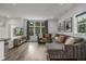 Bright living room features a large window, hard floors, recessed lighting, and comfortable seating at 1754 W 66Th Ave, Denver, CO 80221