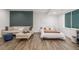 Finished basement with modern sofa, queen sized bed, and wood-look floors at 1754 W 66Th Ave, Denver, CO 80221