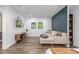 Finished basement with modern sofa, queen sized bed, and wood-look floors at 1754 W 66Th Ave, Denver, CO 80221