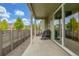 Open patio space with a grill, outdoor seating, and a privacy fence at 1754 W 66Th Ave, Denver, CO 80221