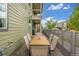 Outdoor dining on a paved patio with wood table, seating and privacy fence at 1754 W 66Th Ave, Denver, CO 80221
