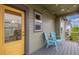 Cozy patio area with light-blue chairs under string lights, and a bright yellow door at 1754 W 66Th Ave, Denver, CO 80221