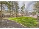 Spacious backyard featuring a well-maintained lawn, wooden fence, and mature trees at 826 Maxwell Ave, Boulder, CO 80304