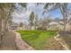 Beautifully landscaped backyard with lush lawn, rock edging, and mature trees at 826 Maxwell Ave, Boulder, CO 80304