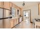 Functional kitchen featuring wooden cabinets, stainless steel appliances, and hardwood floors, with attached desk space at 826 Maxwell Ave, Boulder, CO 80304