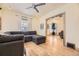 Comfortable living room featuring a gray sectional sofa, hardwood floors, and natural light with open hallway at 826 Maxwell Ave, Boulder, CO 80304
