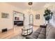 Cozy living room showcases hardwood floors, a plush gray sofa, and a glass coffee table with open archway at 826 Maxwell Ave, Boulder, CO 80304