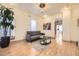 Bright living room featuring hardwood floors, neutral walls, and stylish furnishings with an open hallway view at 826 Maxwell Ave, Boulder, CO 80304