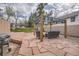 Backyard stone patio with a seating area, metal pergola, and outdoor grill for outdoor dining and entertaining at 826 Maxwell Ave, Boulder, CO 80304