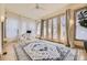 Bright sun room with a ceiling fan, hardwood floors, ample windows and glass doors leading to the backyard at 826 Maxwell Ave, Boulder, CO 80304