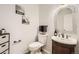 Half bathroom features sink, toilet and decorated walls at 1973 S Pitkin St, Aurora, CO 80013