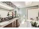 Bright bathroom featuring granite countertops, double sinks, and a soaking tub at 1973 S Pitkin St, Aurora, CO 80013