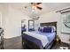 Cozy bedroom with hardwood floors, ceiling fan, and large window at 1973 S Pitkin St, Aurora, CO 80013