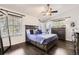 Comfortable bedroom featuring a ceiling fan, hardwood floors and large windows at 1973 S Pitkin St, Aurora, CO 80013