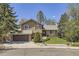 Charming two-story home featuring stone accents, a well-manicured lawn, and mature trees at 1973 S Pitkin St, Aurora, CO 80013