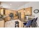Bright kitchen featuring an island with seating, stainless steel appliances and wood cabinetry at 1973 S Pitkin St, Aurora, CO 80013