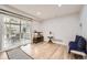 Open-concept living area with hardwood floors, bright natural light, and access to an outdoor patio at 1973 S Pitkin St, Aurora, CO 80013