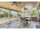 Charming covered patio featuring outdoor seating, ceiling fans, and serene views of the backyard at 1973 S Pitkin St, Aurora, CO 80013