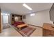 Finished basement with plush carpet, cozy furniture, a built-in bookcase, and a window at 14823 E Colgate Dr, Aurora, CO 80014