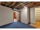 Unfinished basement offers storage space, visible ceiling beams, and doorway with closet at 14823 E Colgate Dr, Aurora, CO 80014