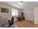 Bedroom features natural light, hardwood floors, an antique armoire, and ample closet space at 14823 E Colgate Dr, Aurora, CO 80014