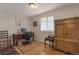 Bedroom features natural light, hardwood floors, an antique armoire, and an office setup at 14823 E Colgate Dr, Aurora, CO 80014