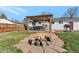 Cozy backyard firepit with stone surround, an outdoor gazebo, and a grill area at 14823 E Colgate Dr, Aurora, CO 80014