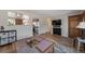 Open-concept living space with hardwood floors, TV, and view into the kitchen and dining area at 14823 E Colgate Dr, Aurora, CO 80014