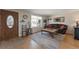 Cozy living room with hardwood floors, large window, a plush sofa, and an ornate front door at 14823 E Colgate Dr, Aurora, CO 80014