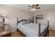 Comfortable main bedroom featuring a classic bed frame, a ceiling fan, and wood flooring at 14823 E Colgate Dr, Aurora, CO 80014