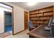 Office with built-in shelves, neutral carpet, and a door to another room at 14823 E Colgate Dr, Aurora, CO 80014