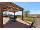 Covered outdoor patio with a dining table set, fire pit, grassy backyard and views of the open space at 14823 E Colgate Dr, Aurora, CO 80014
