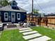 Landscaped backyard featuring modern outdoor living space with an 'Art Bar', fire pit, and patio at 3242 N Williams St, Denver, CO 80205