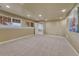 Spacious basement area featuring neutral carpeting and natural light from the window wells at 22021 Pebble Brook Ln, Parker, CO 80138